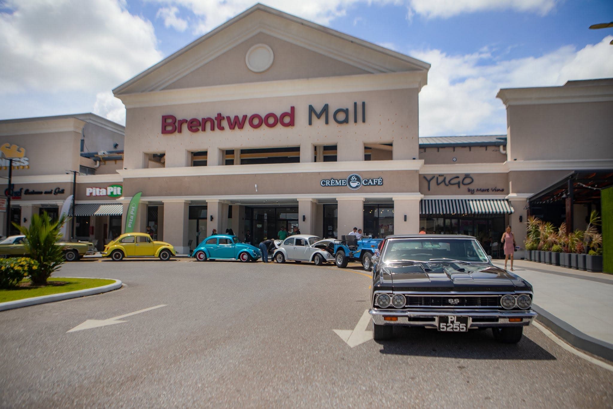 The grand entrance of Brentwood Mall during a classic car show